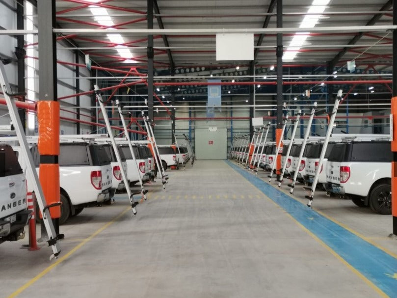 fleet of commercial work trucks with drop down ladders racks for contractors