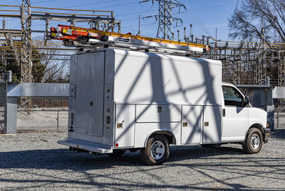 white work van with ladder rack on top