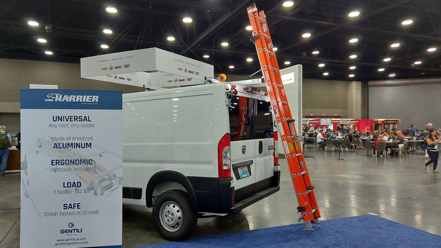 white ram promaster with drop down ladder rack with red ladder