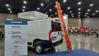 white ram promaster with drop down ladder rack with red ladder