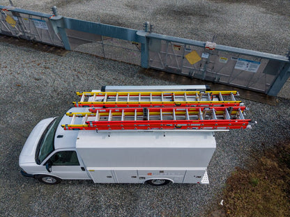 top of white work van with ladders stored on drop down ladder rack
