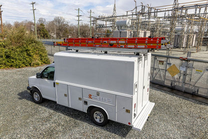 white van with roof rack and stored ladders