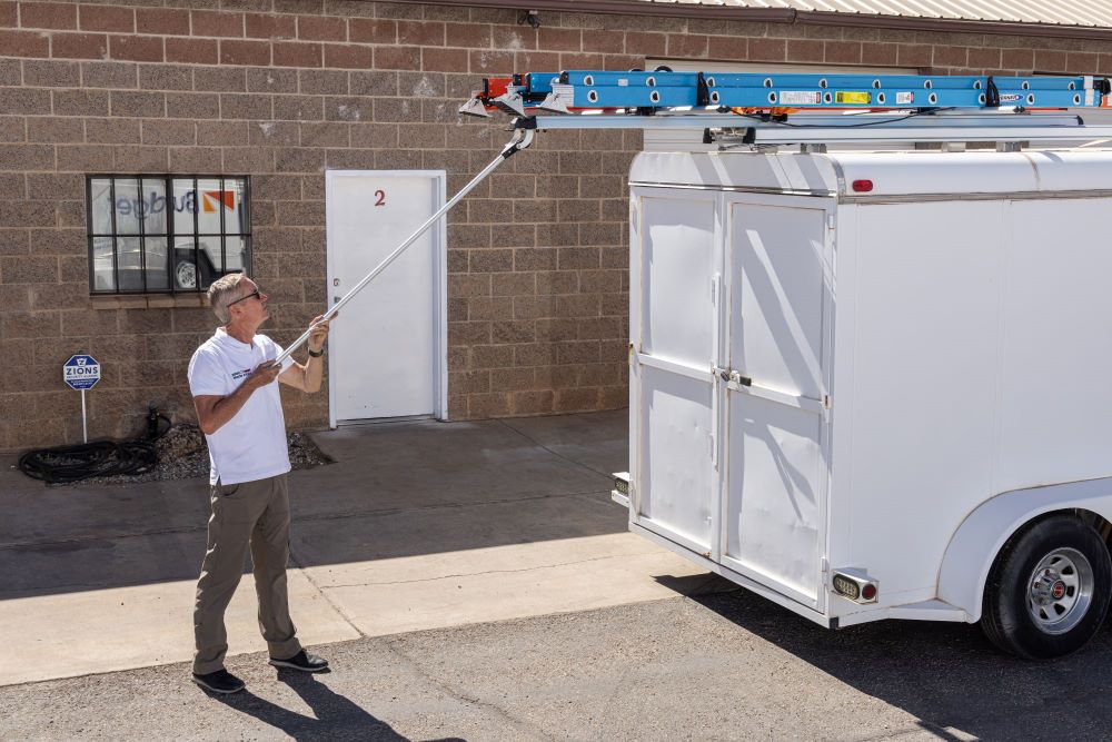 contractor commercial cargo enclosed trailer with drop down ladder rack with blue ladder