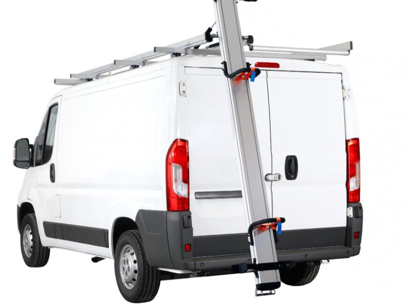 White commercial cargo van with a ladder rack drop down