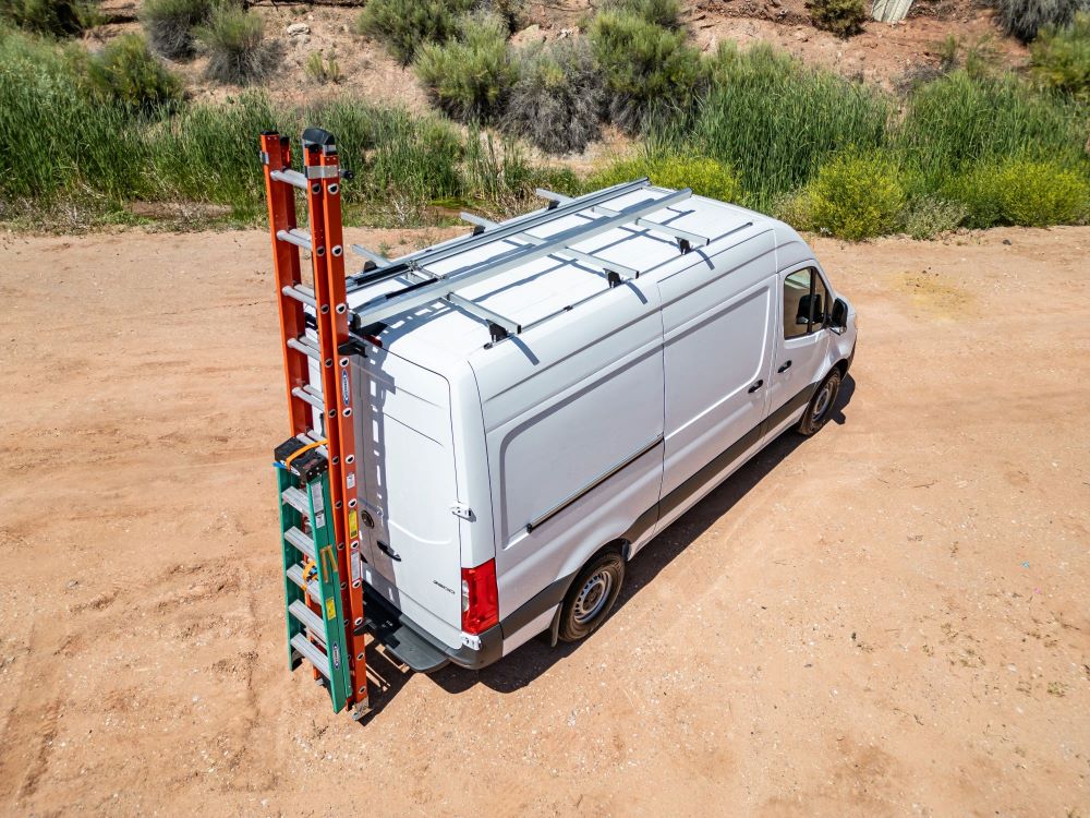 white work commercial sprinter fleet contractor van with drop down ladder rack holding 2 ladders